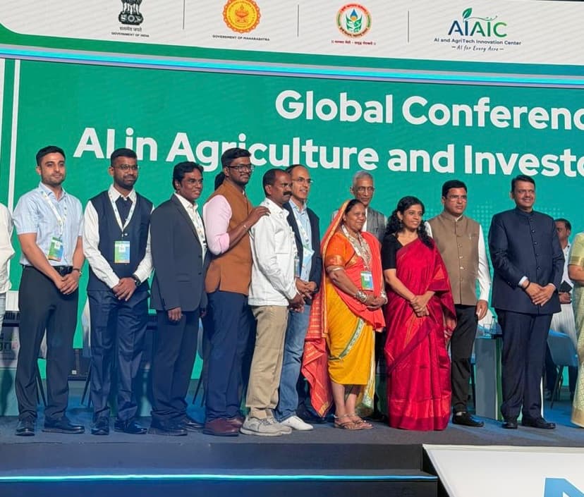 Muneender Jillella and Aditya Chhabra on stage with CM Devendra Fadnavis at AI4Agri 2026